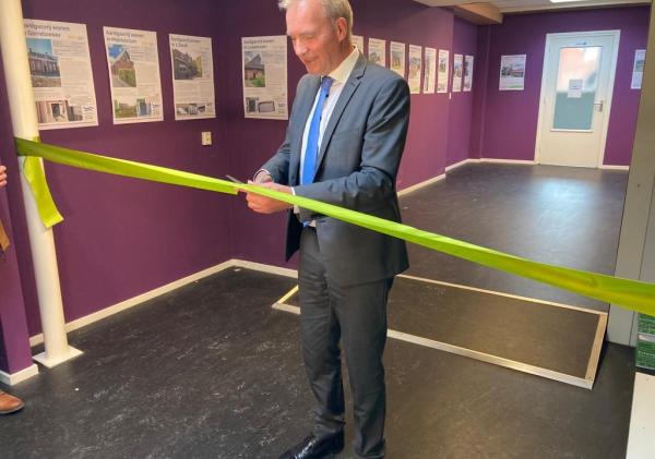 Wethouder Meindert Joostens knipt een lint door als opening van de postergalerij.